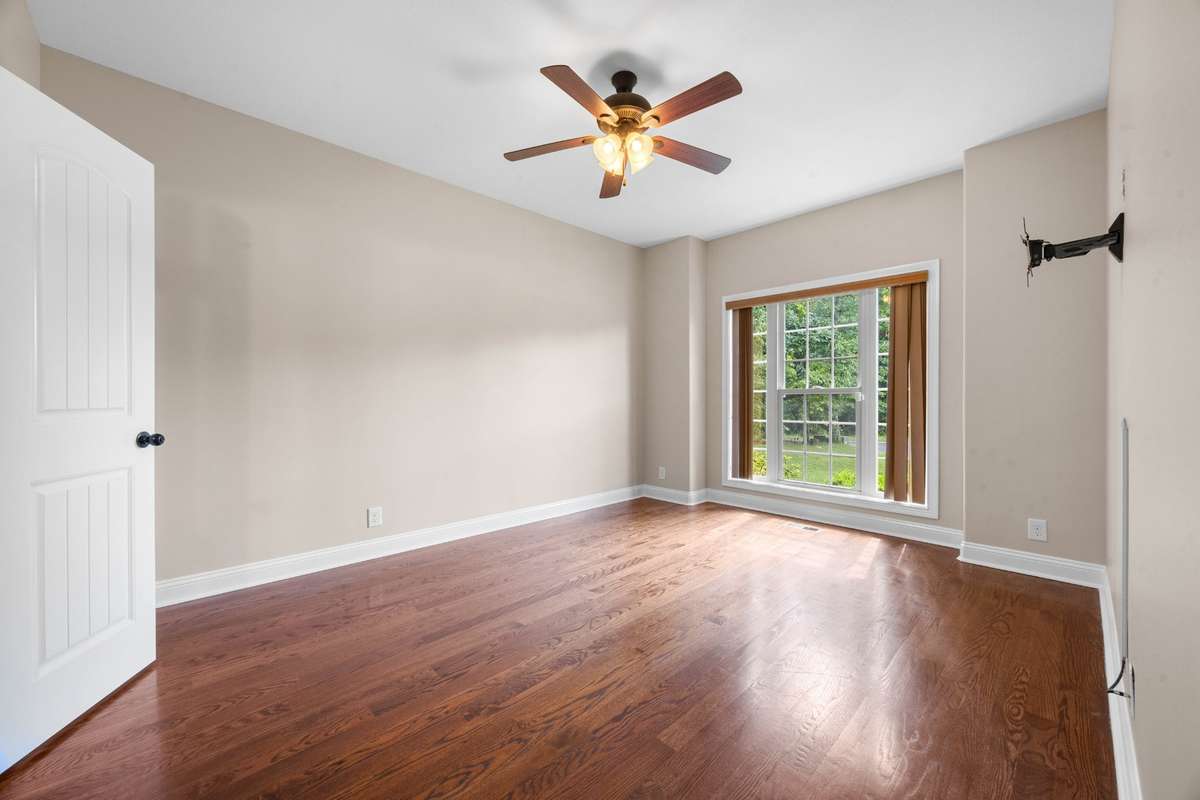 This bedroom is on the main level. It features a walk-in closet and a full bathroom