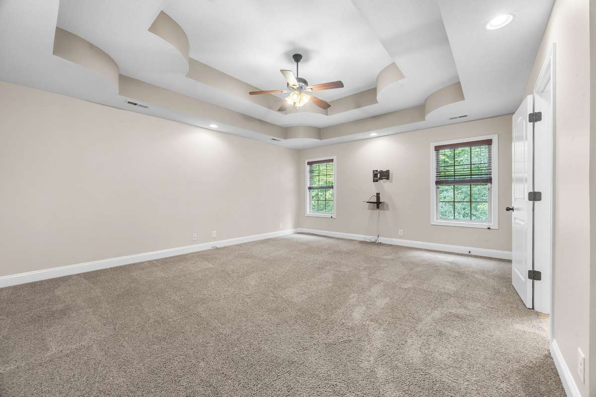 Den/Bonus Room/5th Bedroom features tray ceiling and a half bath