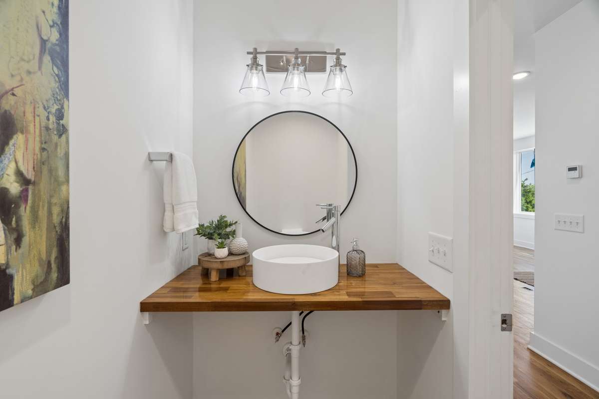 Half bath serving living and kitchen areas