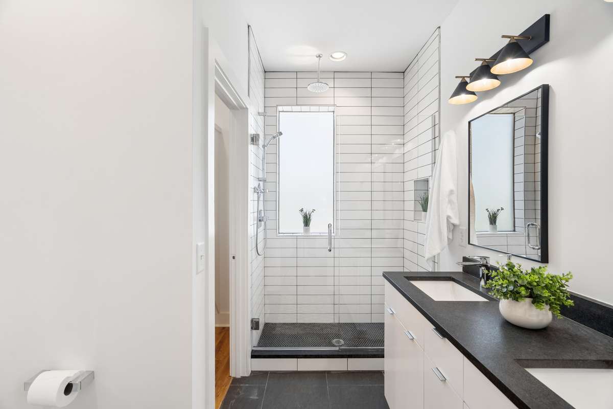Walk in tiled shower with glass door