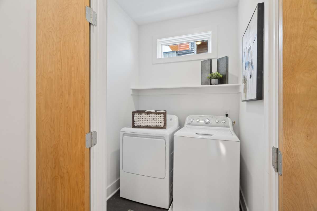 Walk in laundry area with storage shelf