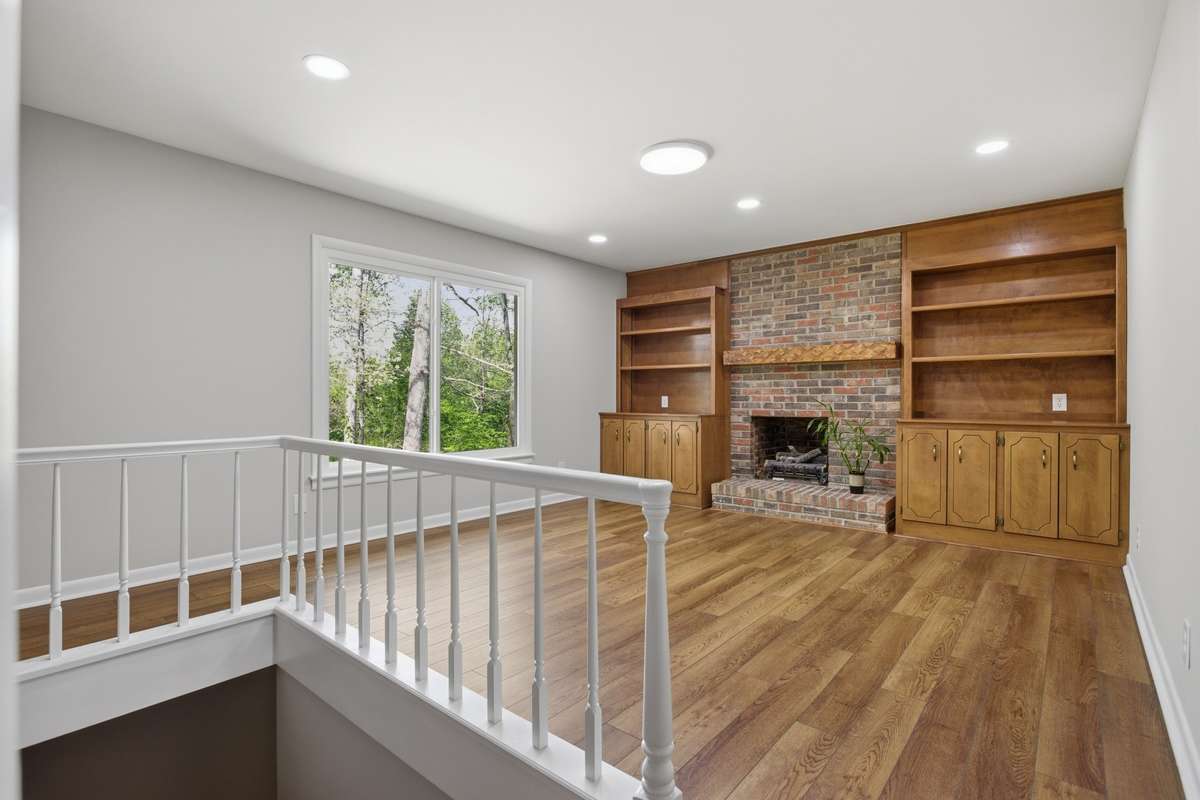 Den on main level with gas fireplace and built-ins