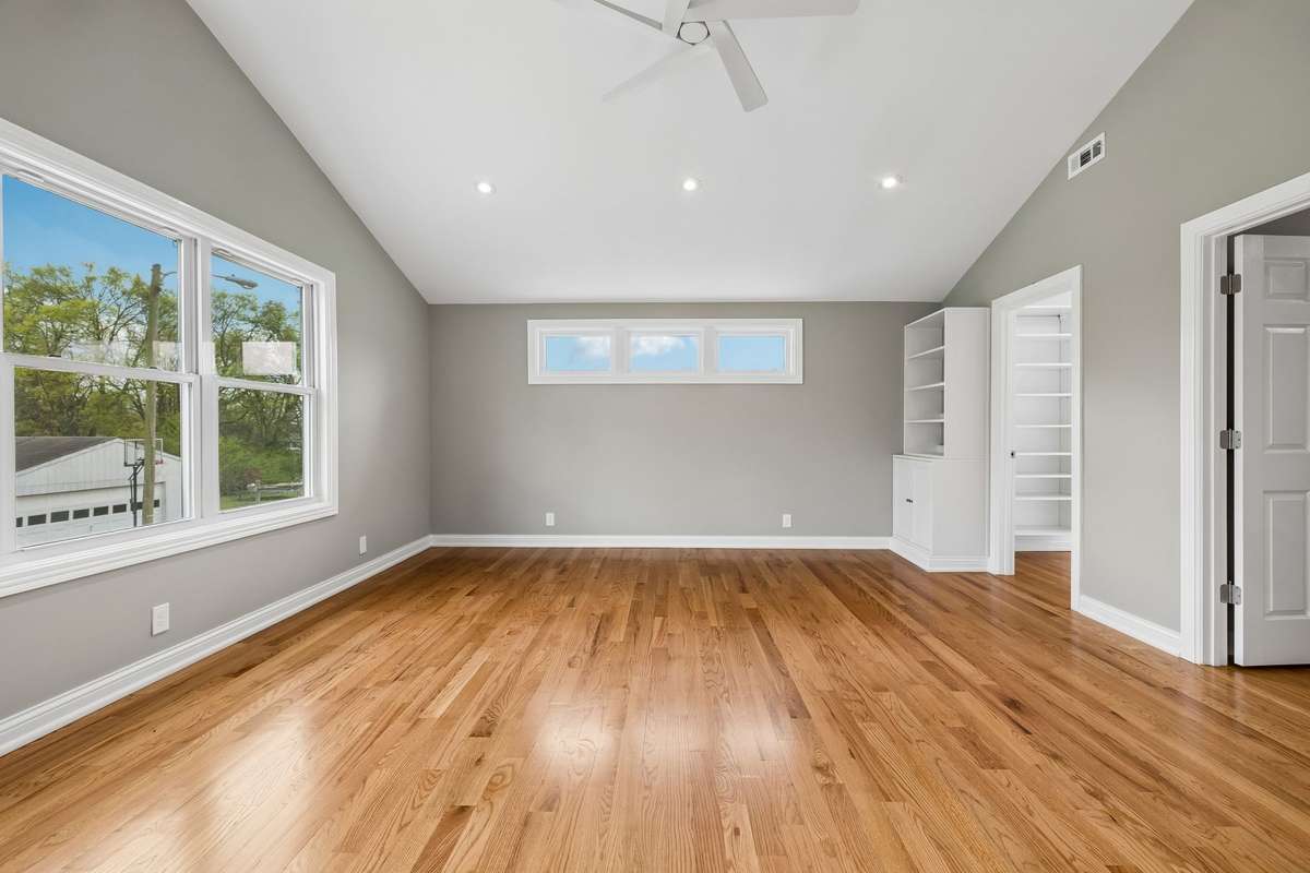Another view of primary with built ins and the closet on right