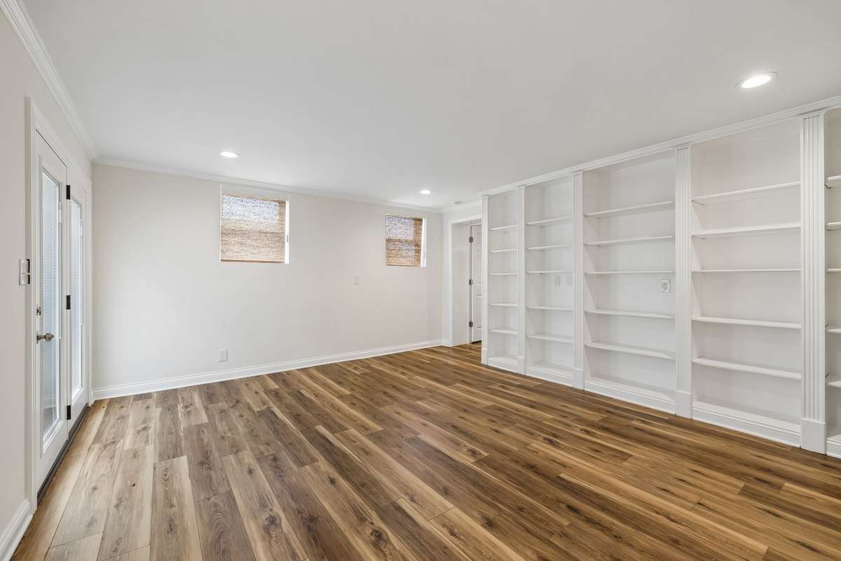 Another view of basement bedroom showing the builtin bookcases
