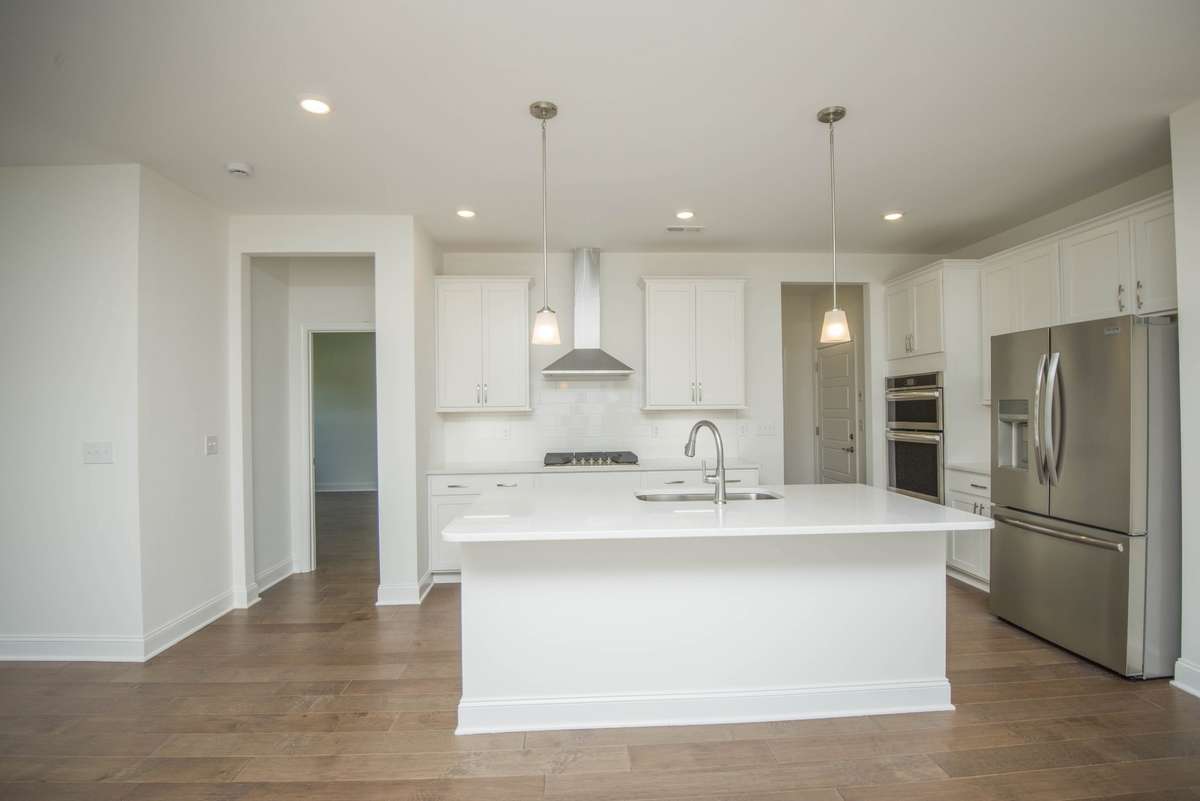 Photos displayed are of a model home. Actual options, finishes, colors, and selections may differ in the home being offered for sale.