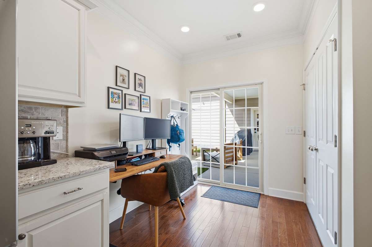 Additional flex space adjacent to the kitchen, perfect for a mud room, home office, or breakfast nook.