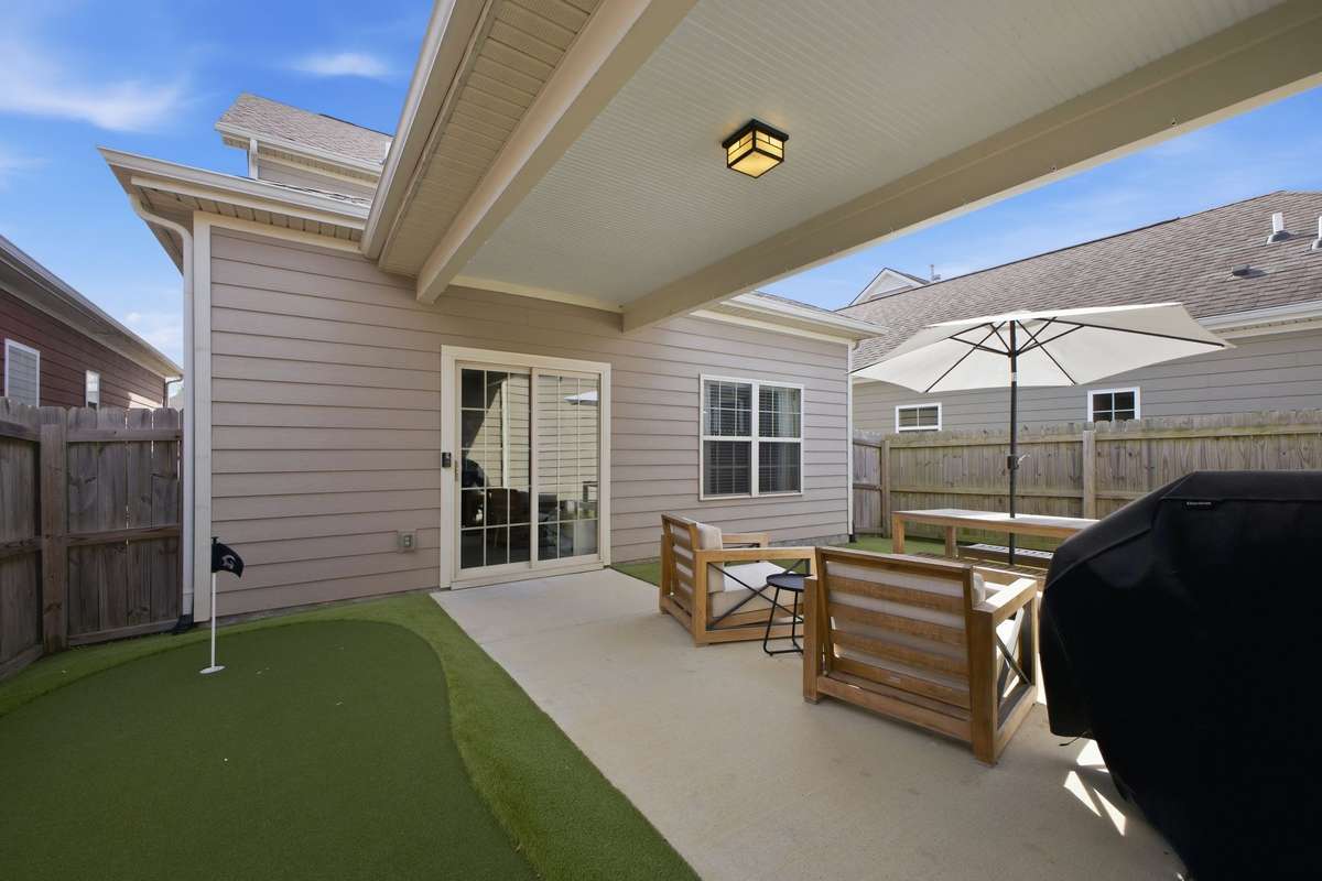 Backyard with fresh turf and a private putting green
