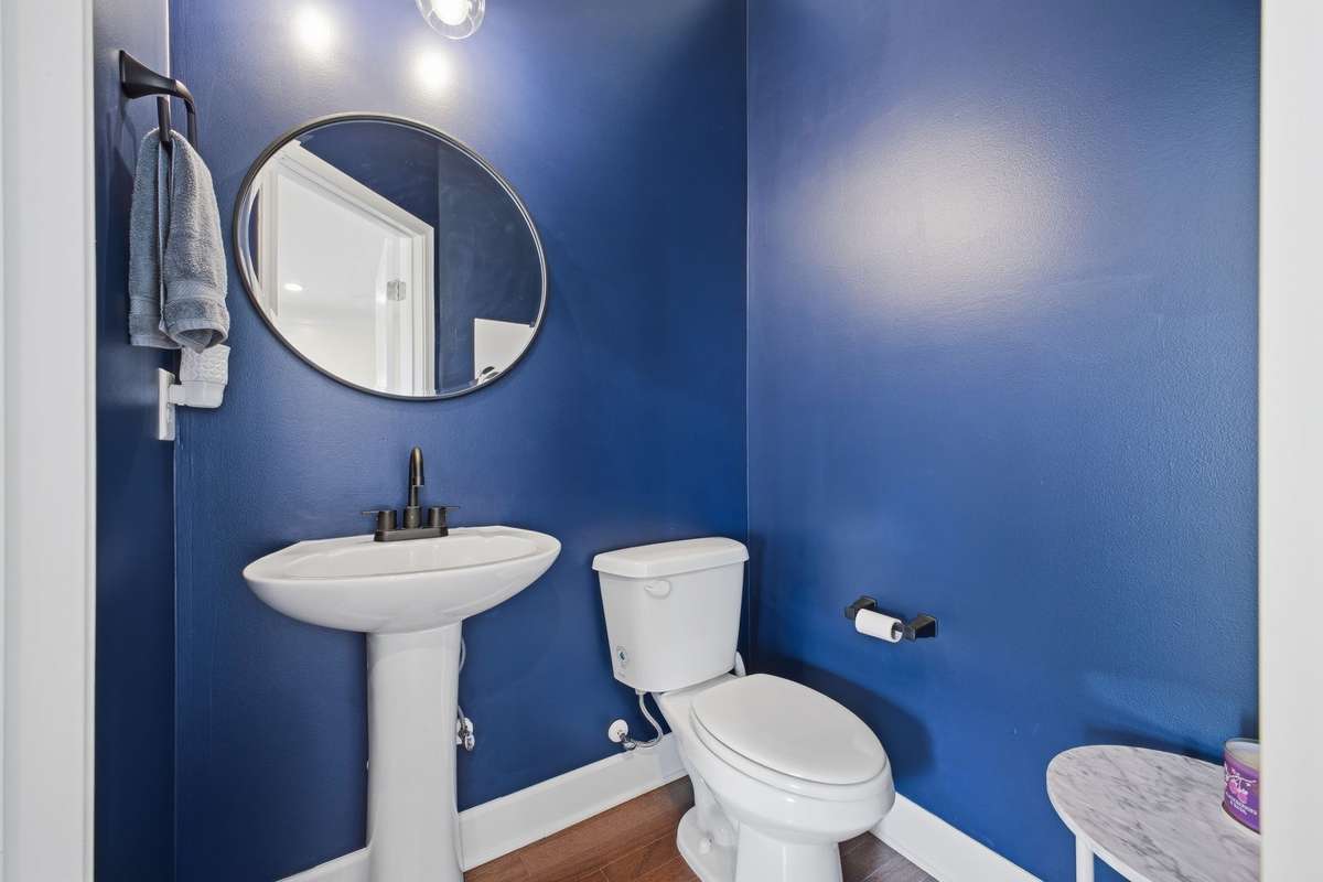 Convenient half bathroom located on the first floor for guests and everyday use.
