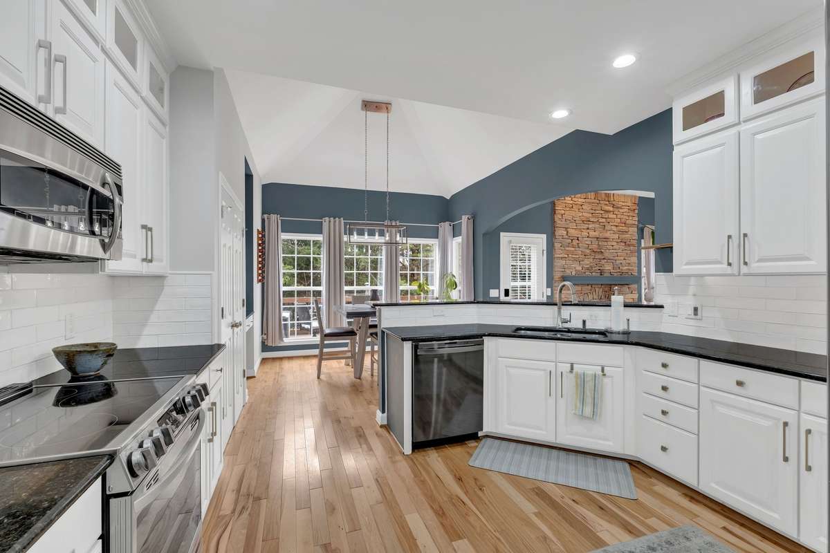 The open-concept kitchen is an entertainer’s dream, seamlessly flowing into the living area & to the outdoor space with its granite countertops and high-end stainless steel appliances!