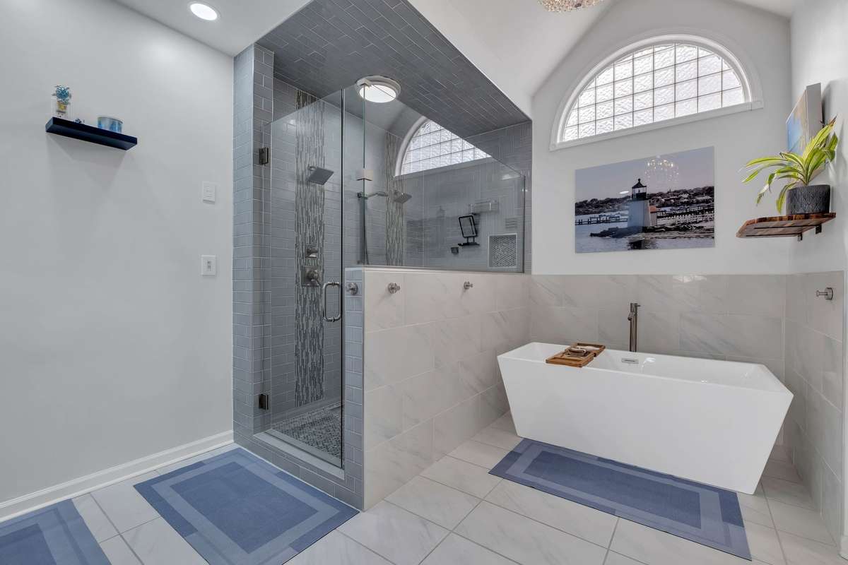 Double shower heads, large soaking tub, high ceilings, water closet and linen closet!