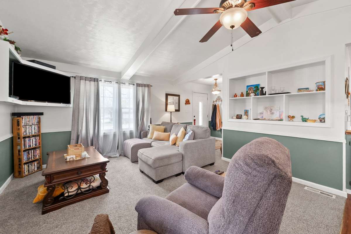 Another view of the living room with built-in shelves