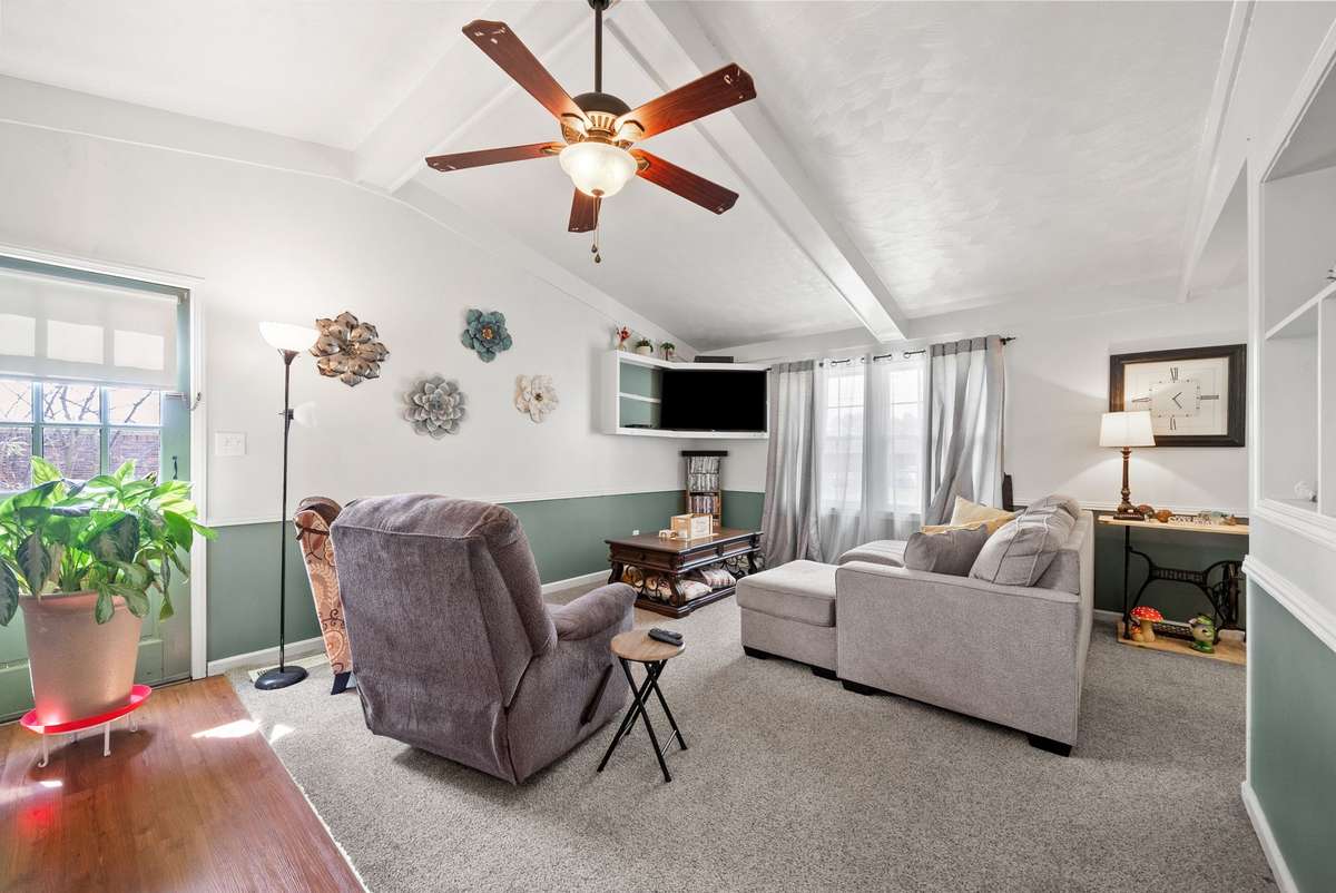 Living room with carpet and ceiling fan