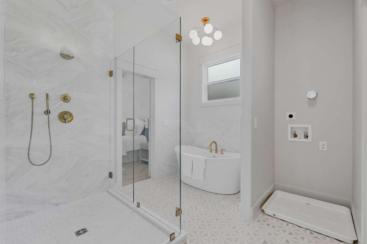 Primary bathroom w/ separate tub and shower. Even space for stackable washer/dryer.