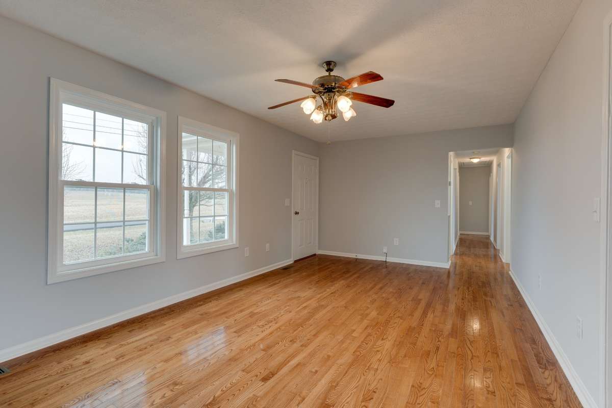 Hardwood flooring continues down the hall, where each bedroom has brand new carpet!