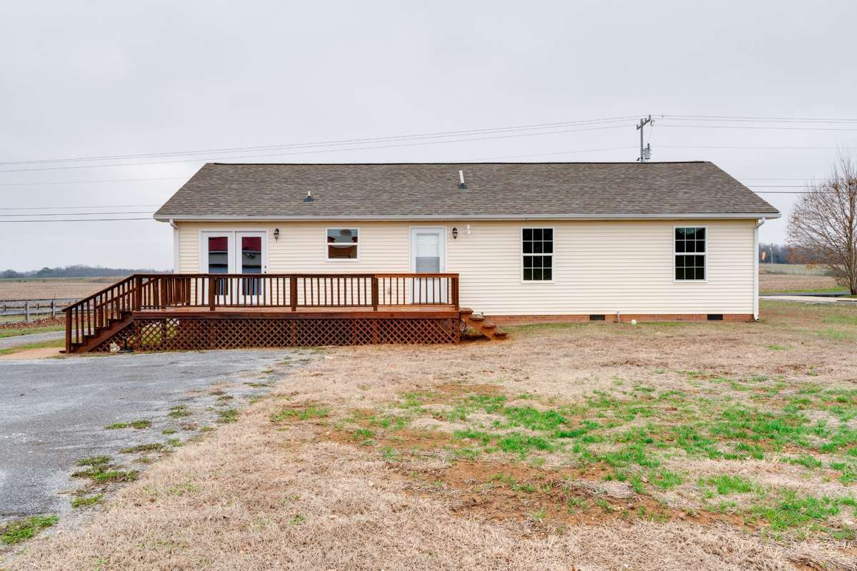 View of the rear of this home.  Notice the TWO BACK DOORS! (One off the dining area and one from the laundry/mud room.