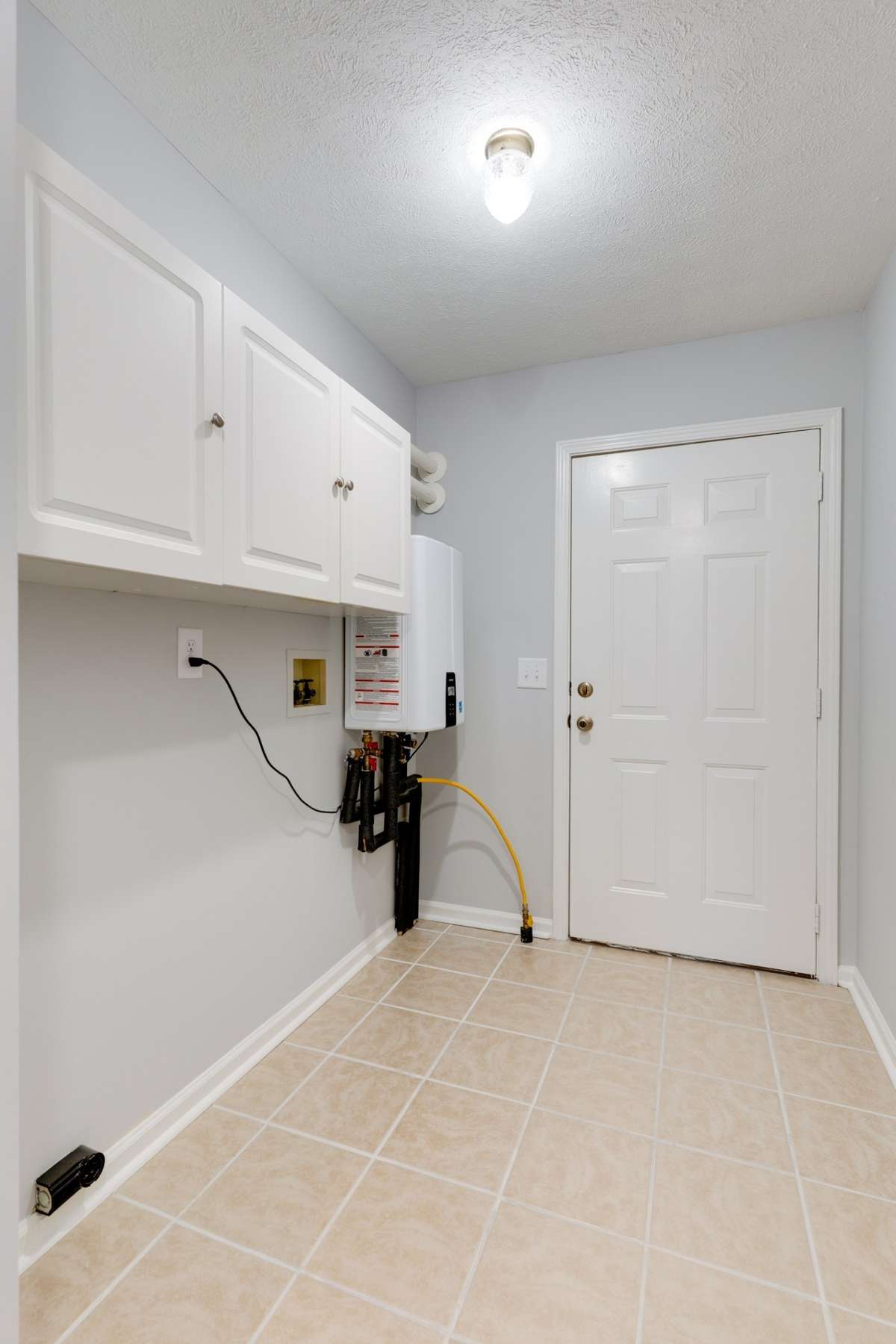 One of this home's greatest upgrades is right there in the corner - a $4,000 tankless hot water heater, providing endless hot water at a real energy and money savings over a tank water heater.
