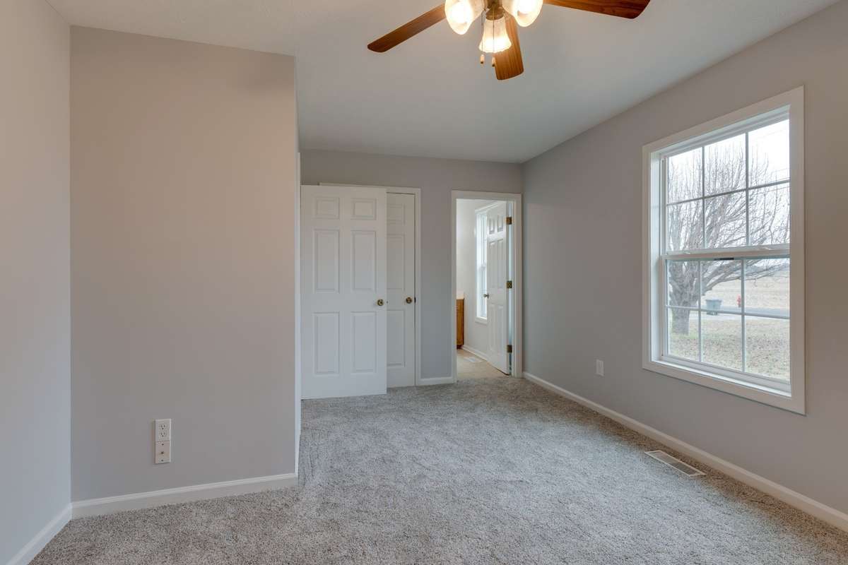 Another view of primary, showing entry to full bath.
