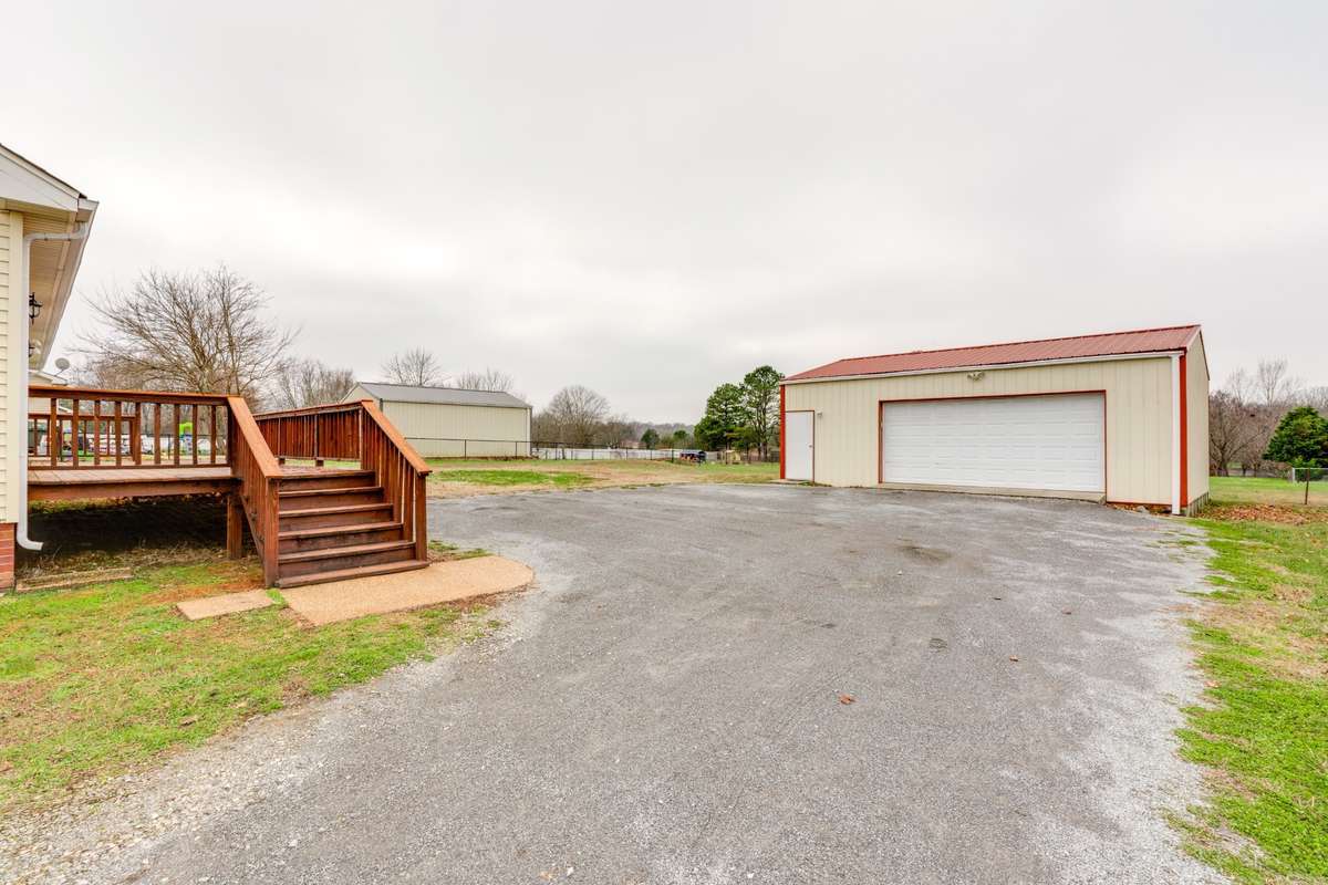 Oversized detached garage with electricity also has a lockable walk-through door.