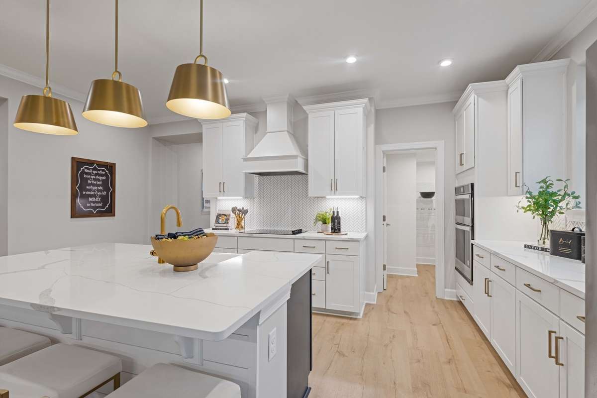 Stunning gourmet kitchen includes built in wall oven/microwave/hood vent, cabinets to the ceiling, quartz countertops, ceramic tile backsplash! New elevated island with additional cabinetry will be installed in this home.