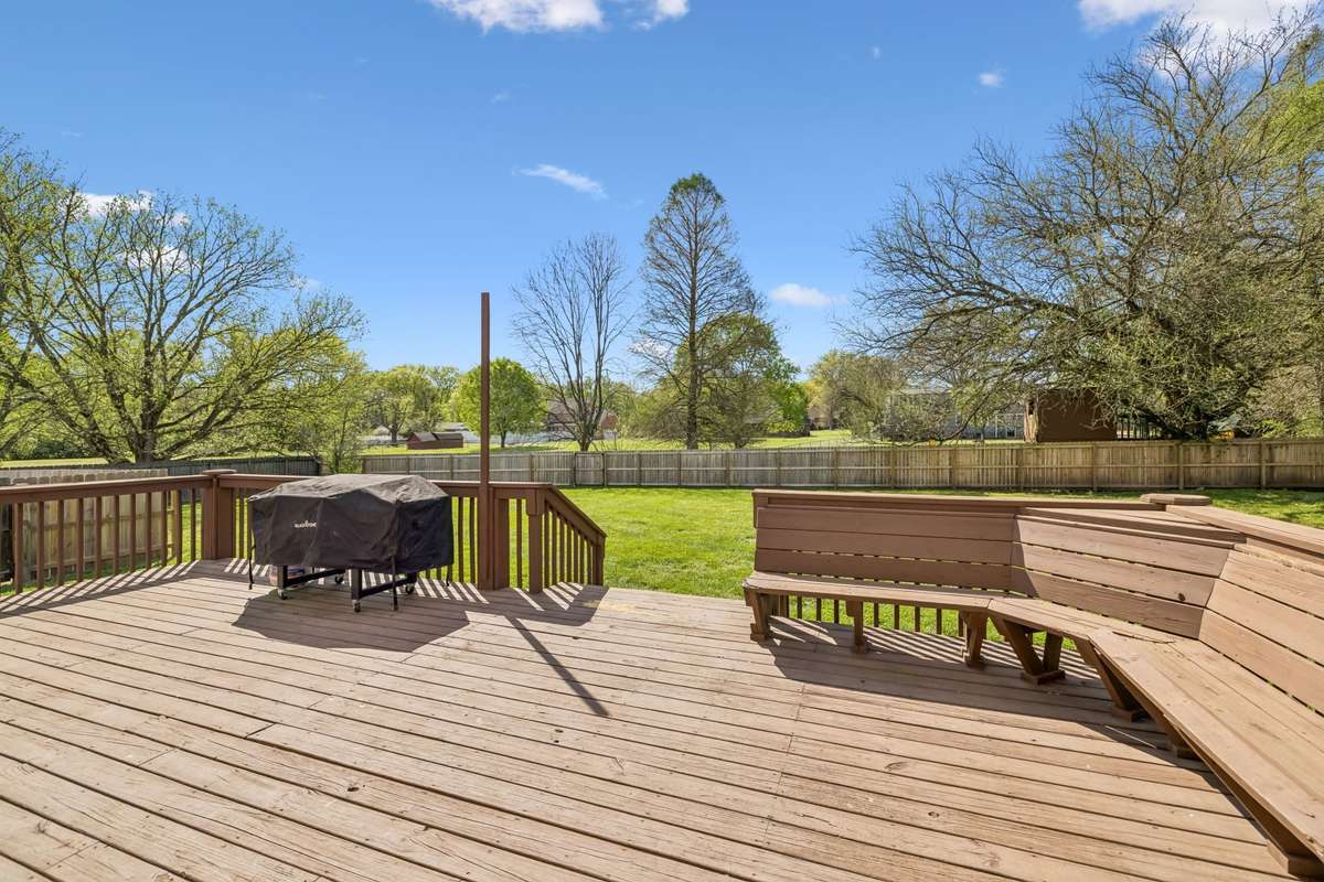 large backyard deck with built-in seating