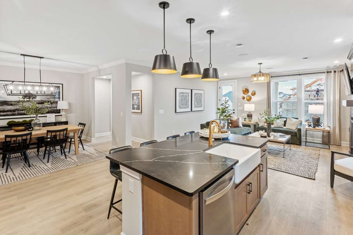Gorgeous gourmet kitchen features double wall ovens, cabinets to the ceiling, quartz countertops, SS appliances, and ceramic tile backsplash.