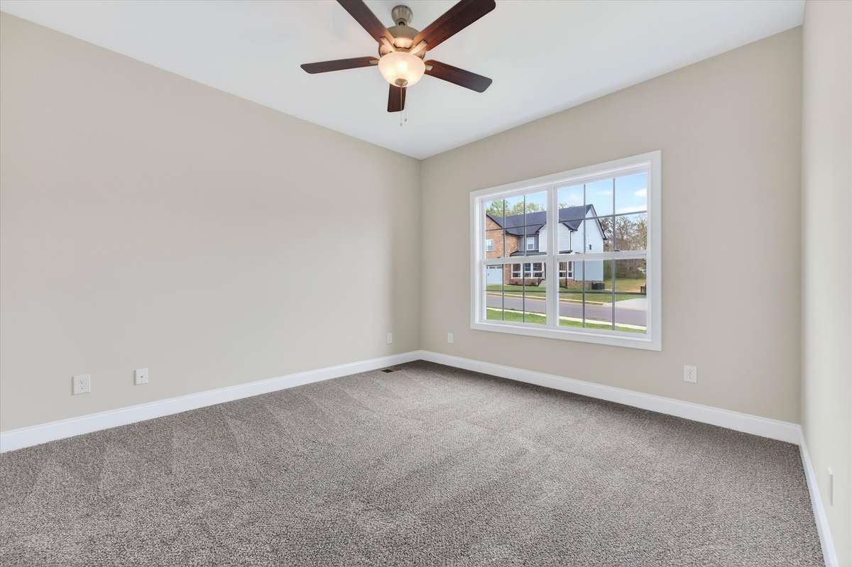 Spacious secondary bedroom with ceiling fan and great natural light.
