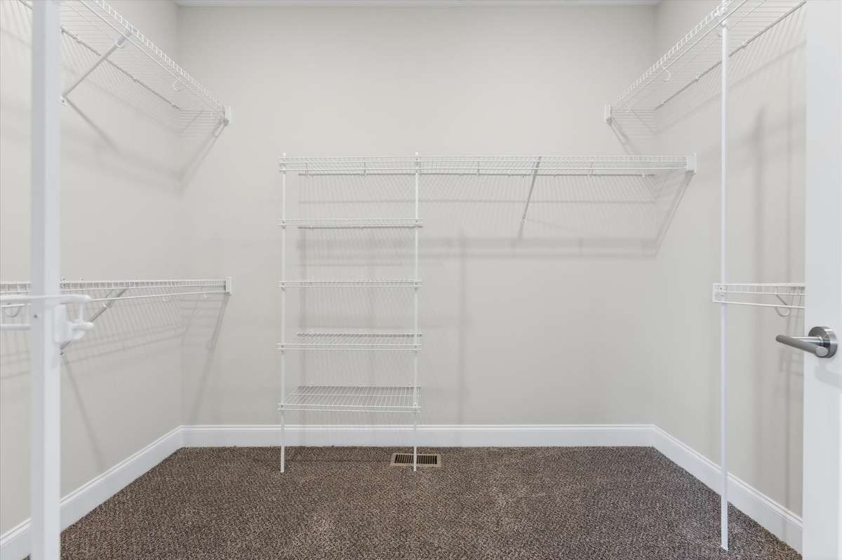 Large walk-in closet with built-in shelving and storage
