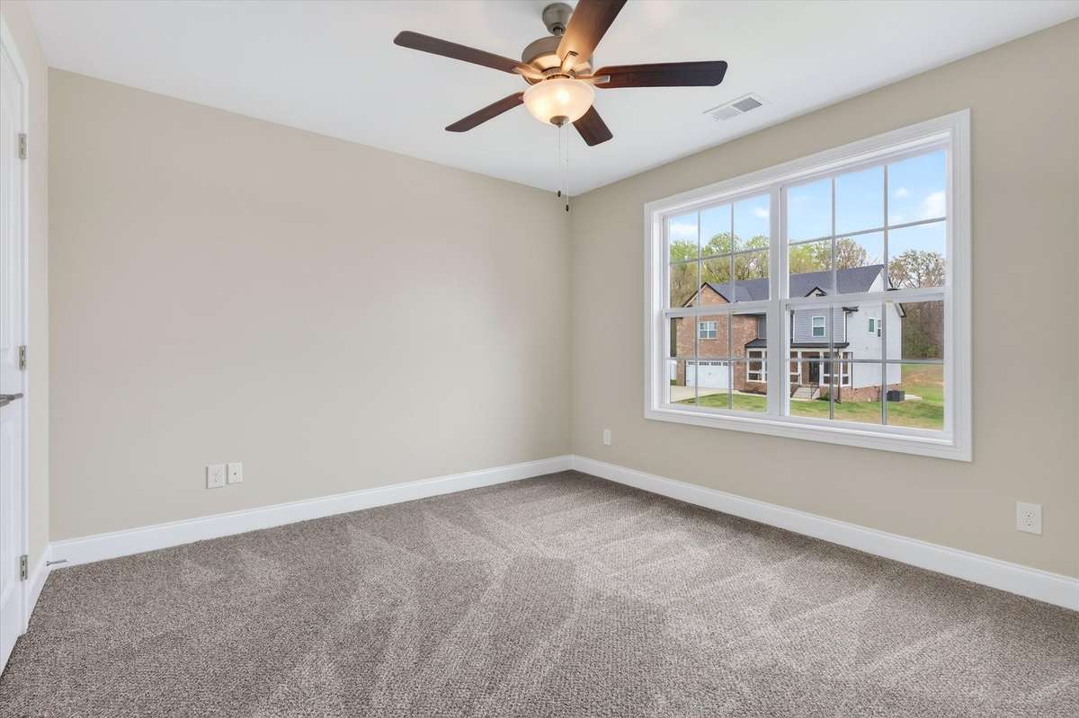 Comfortable bedroom featuring large window and natural light.