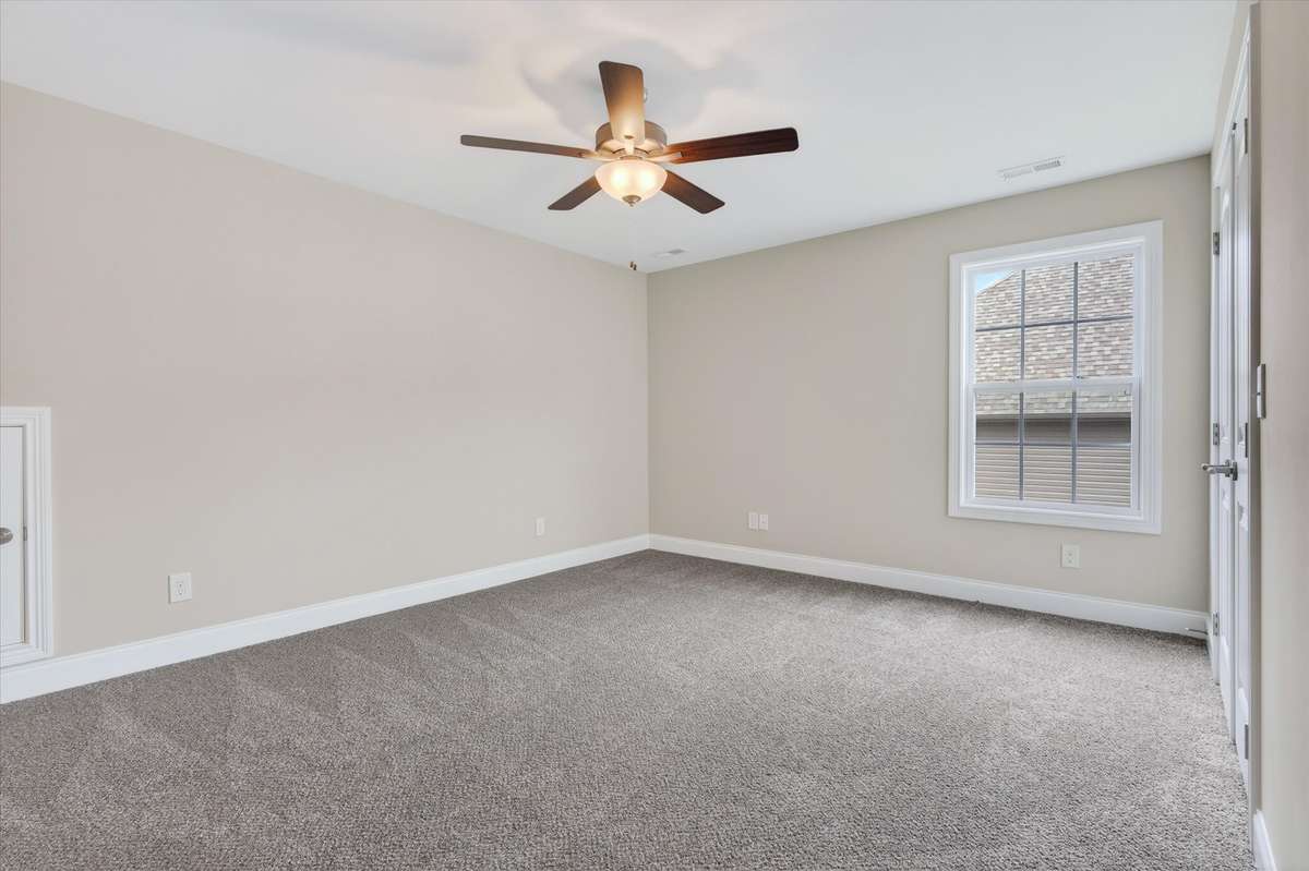 Additional bedroom with ceiling fan and functional layout