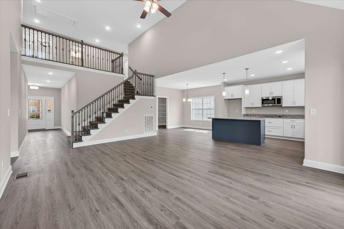Expansive living space with open staircase and modern design