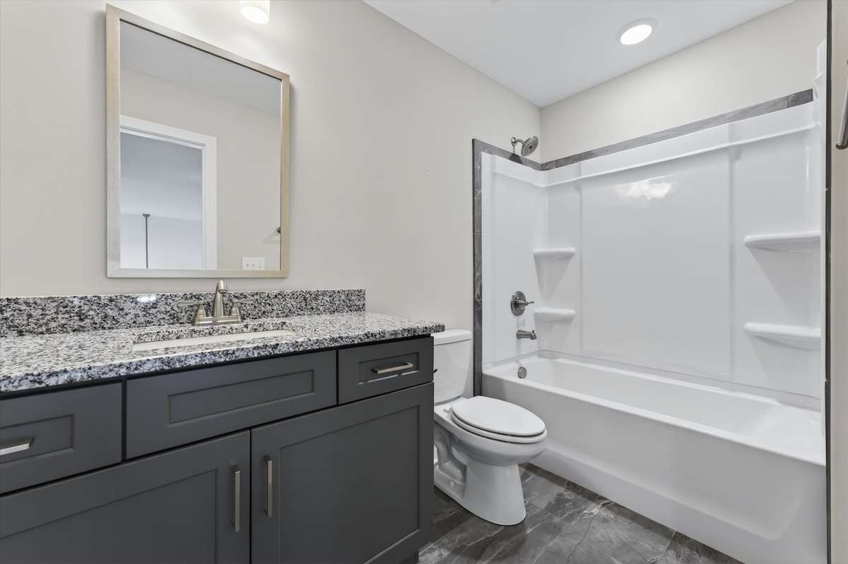 Bathroom vanity with granite countertops and modern cabinetry.