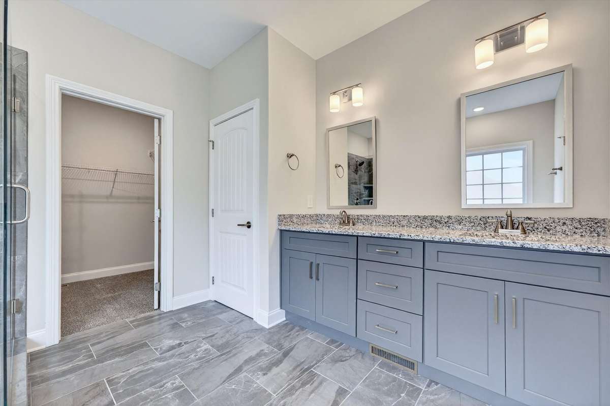 Double vanity with granite countertops and ample storage