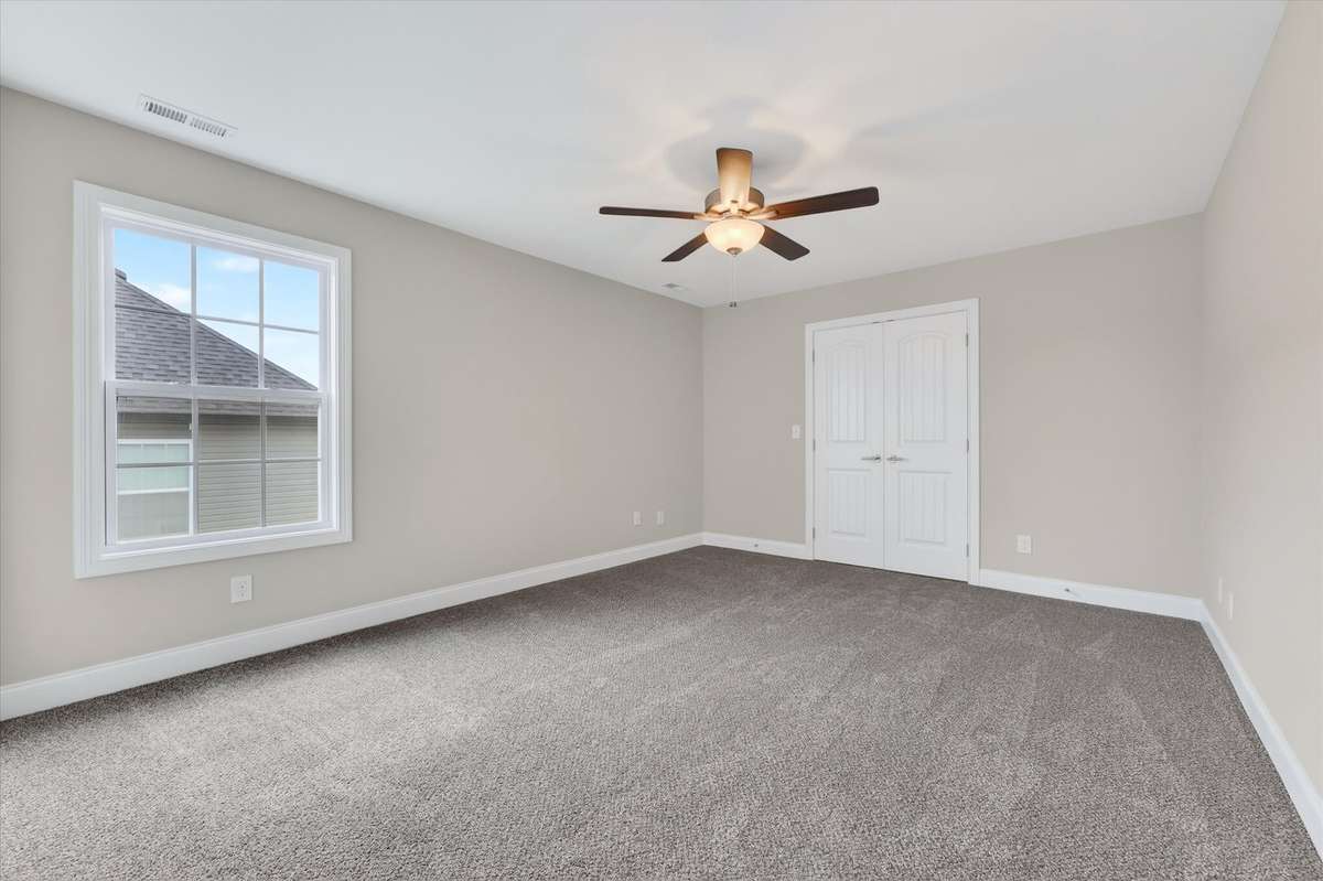 Bright bedroom with neutral tones and ample closet space