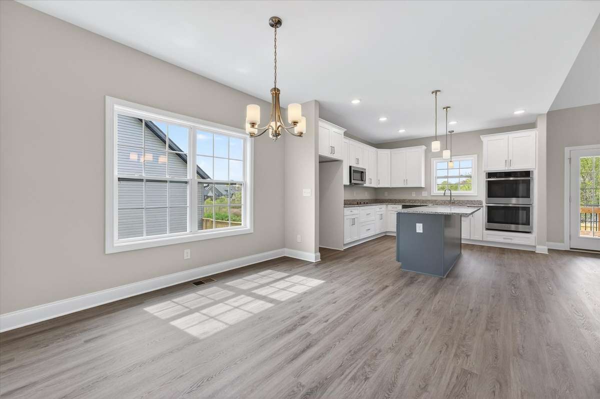 Updated kitchen with large island, ample cabinetry, and open layout.