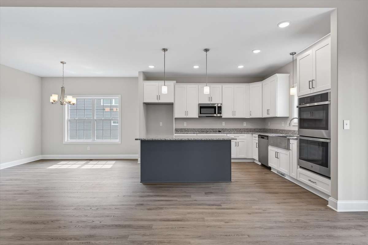 Updated kitchen with large island, ample cabinetry, and open layout.