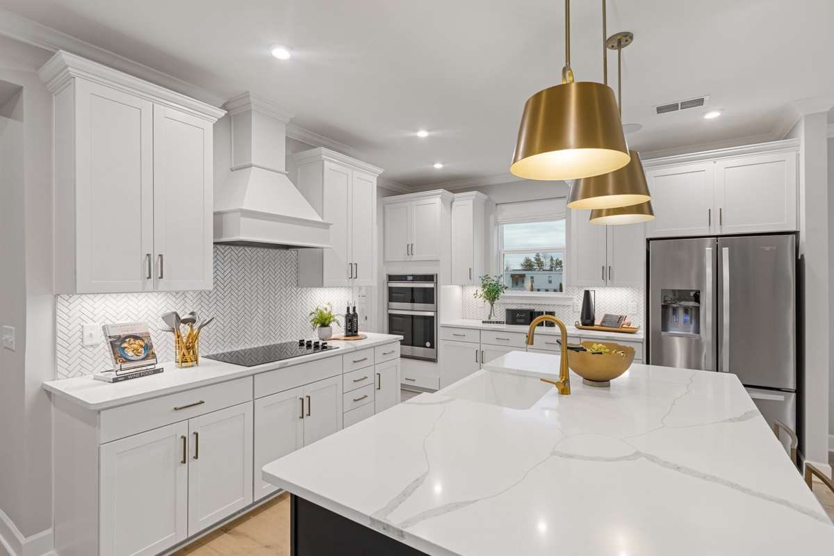 Stunning gourmet kitchen includes built in double wall ovens, cabinets to the ceiling, quartz countertops, ceramic tile backsplash, and SS appliances! Choose from 2 kitchen layouts at NO COST!! New elevated island design included and not pictured.