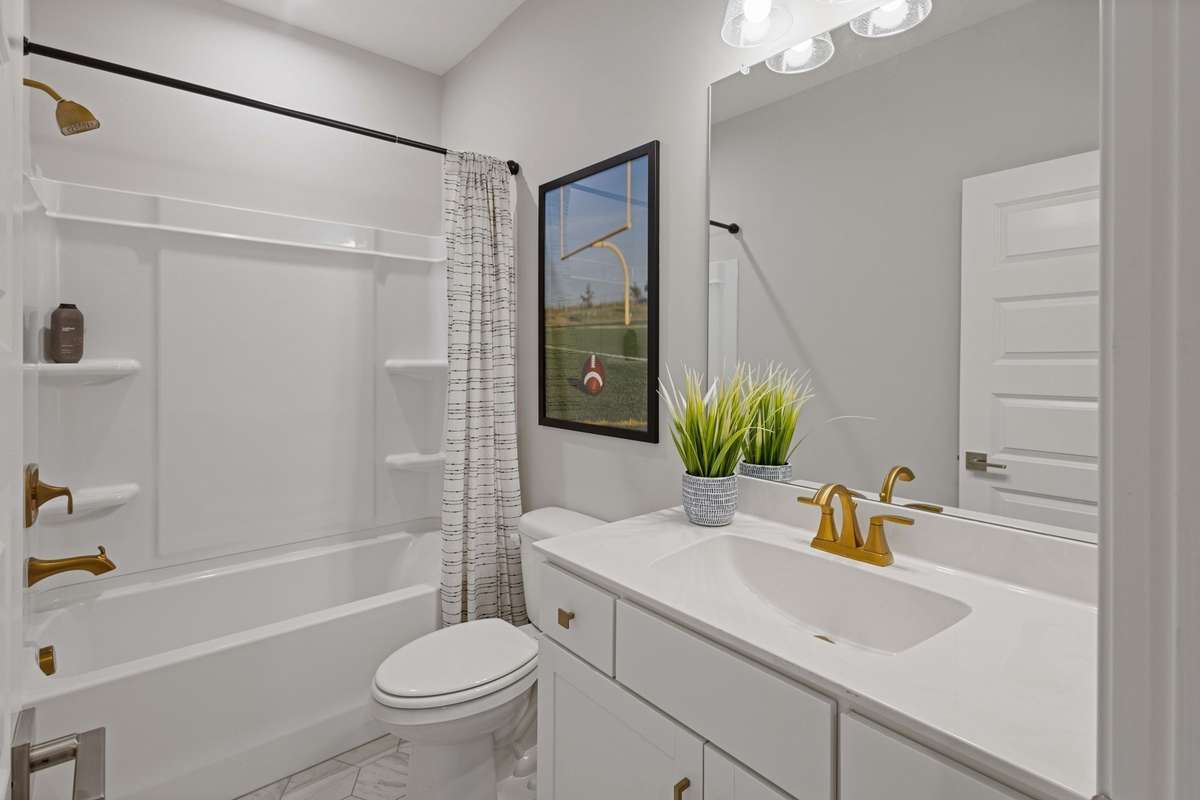 Guest suite upstairs features full bathroom & walk-in closet.  Quartz countertops & ceramic tile flooring is included! Optional tile above tub or full shower available.