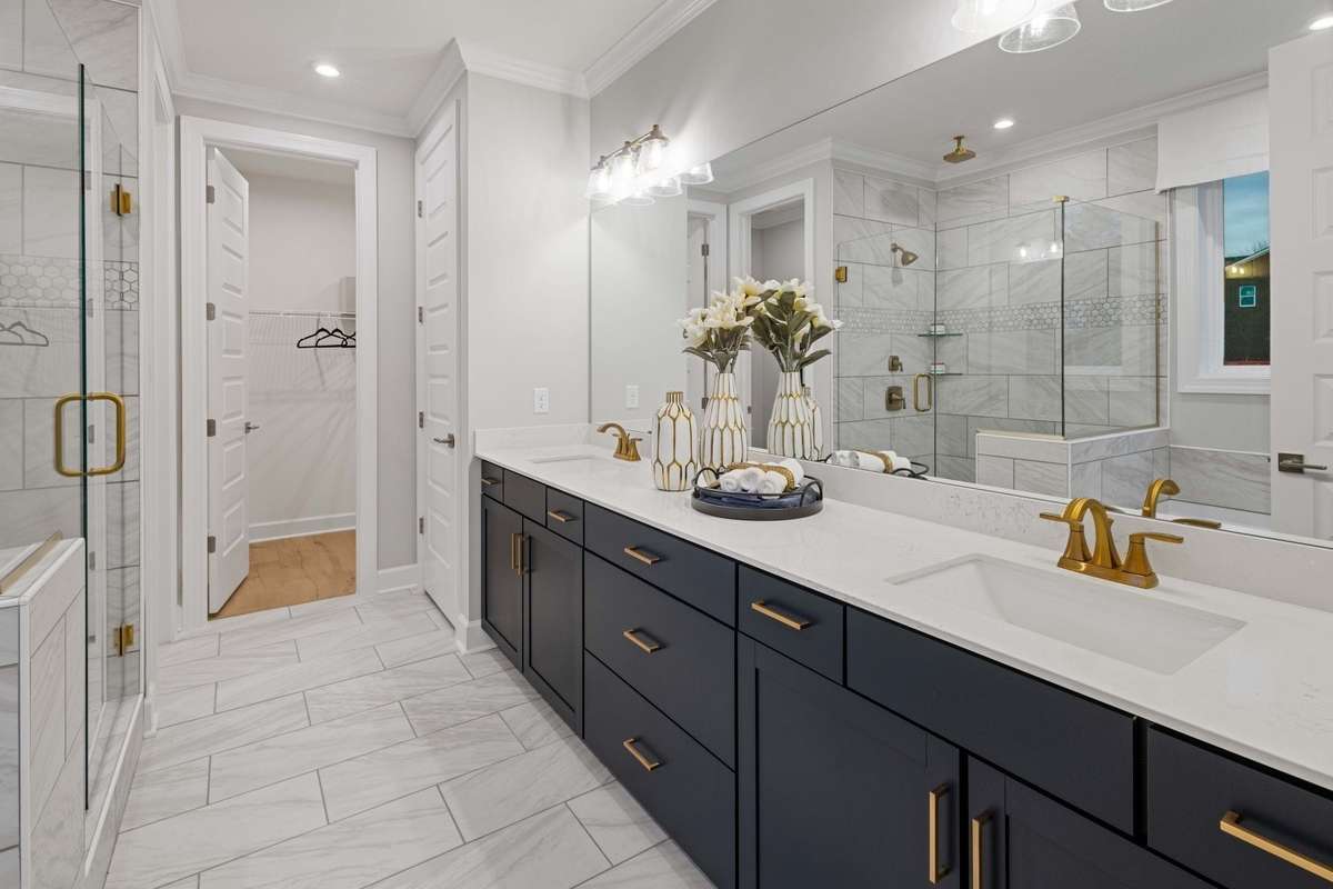 Live in luxury in your primary suite oasis featuring tiled walk-in shower, tile floors, double vanities, and quartz countertops! Choose between shower with linen or shower and tub at NO COST!