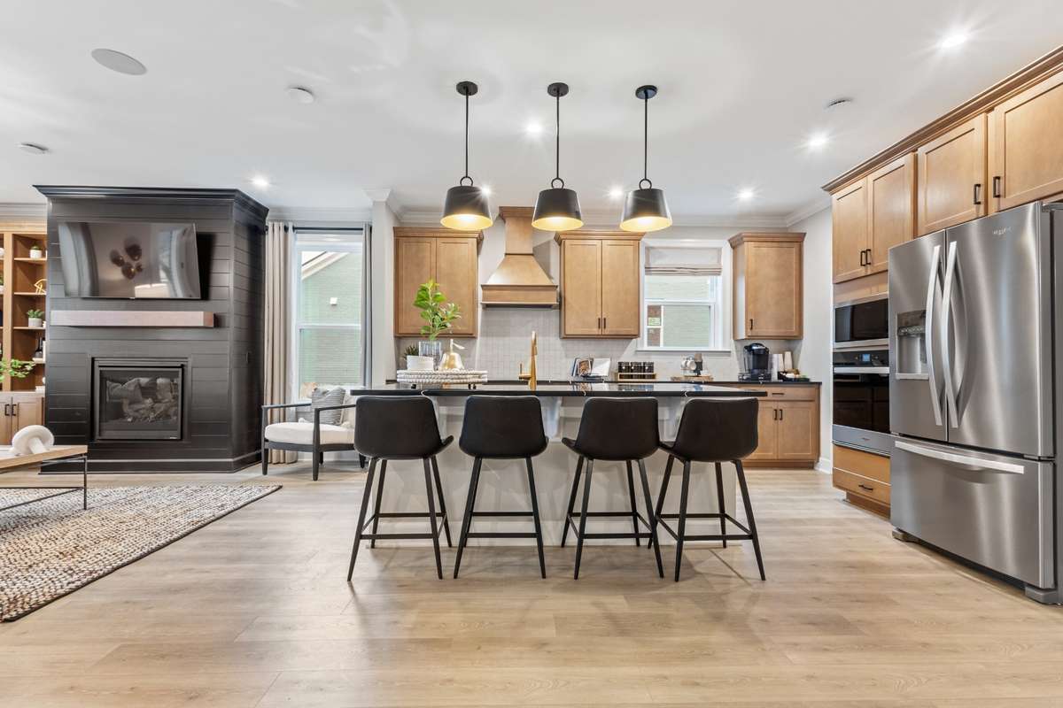 Gorgeous gourmet kitchen features double wall ovens, cabinets to the ceiling, quartz countertops, SS appliances, and ceramic tile backsplash. Choose between TWO layouts at NO COST! New elevated island not shown here is included.
