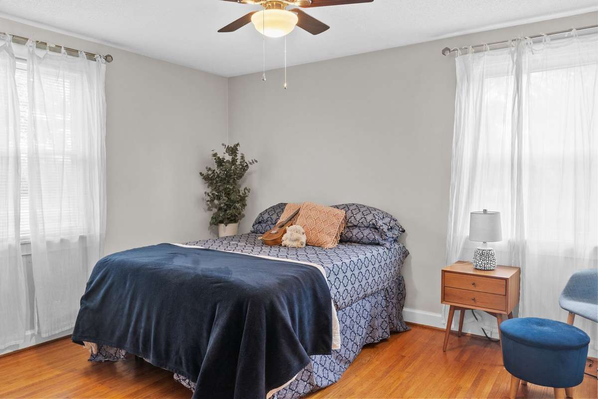 Bedroom #2 is the largest of all 3- Seller is using this as the "Primary" bedroom- has beautiful original hardwood floors and vinyl windows