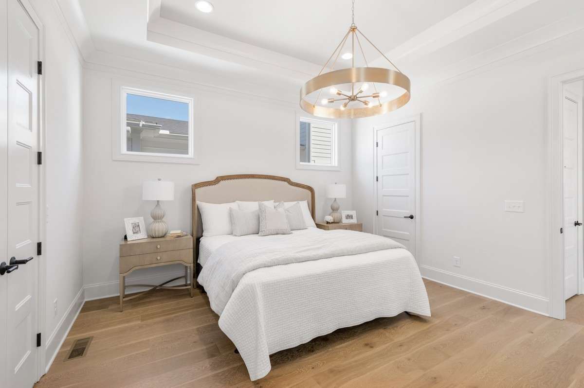 Primary Bedroom with hardwood flooring.