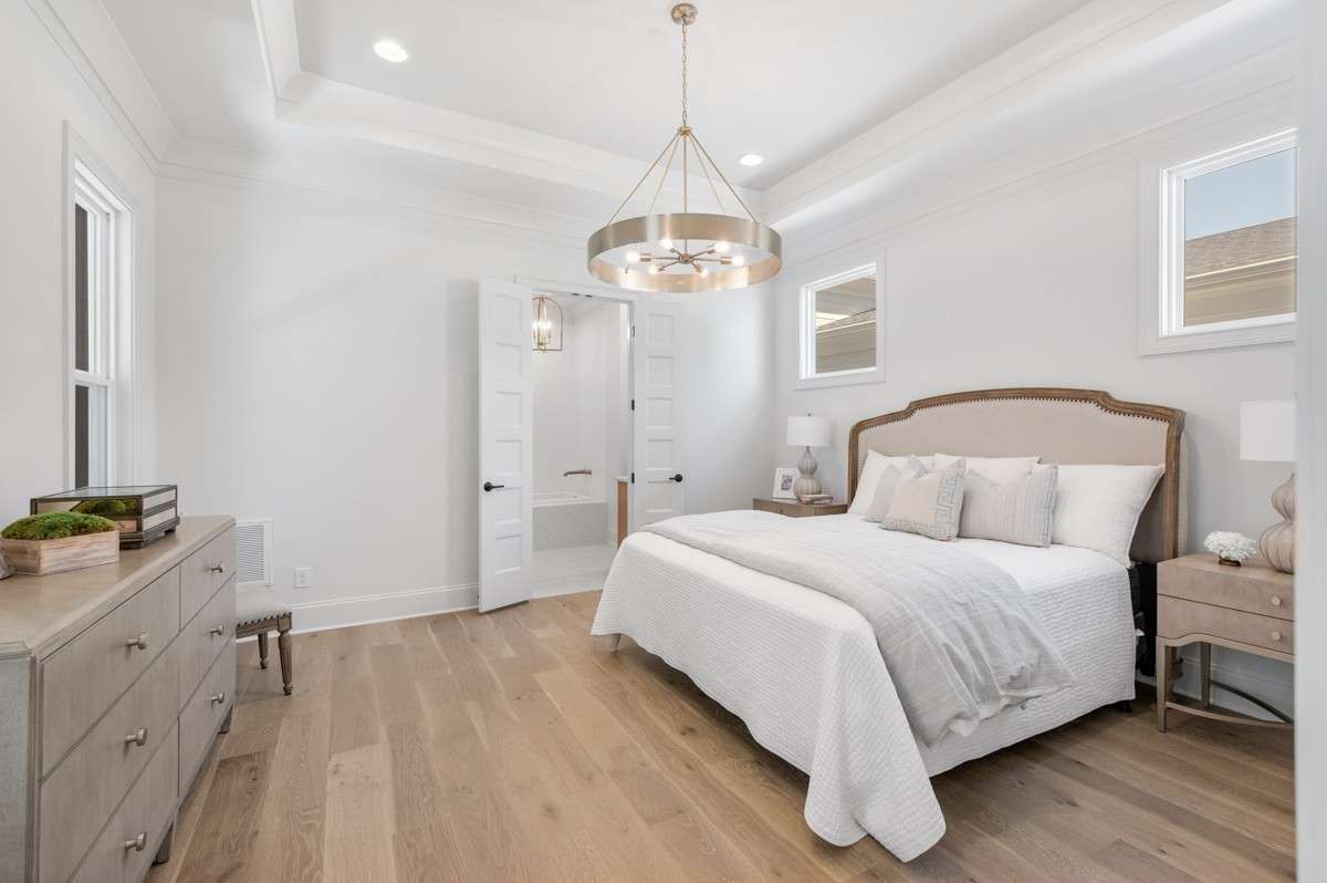 Primary Bedroom with hardwood flooring.