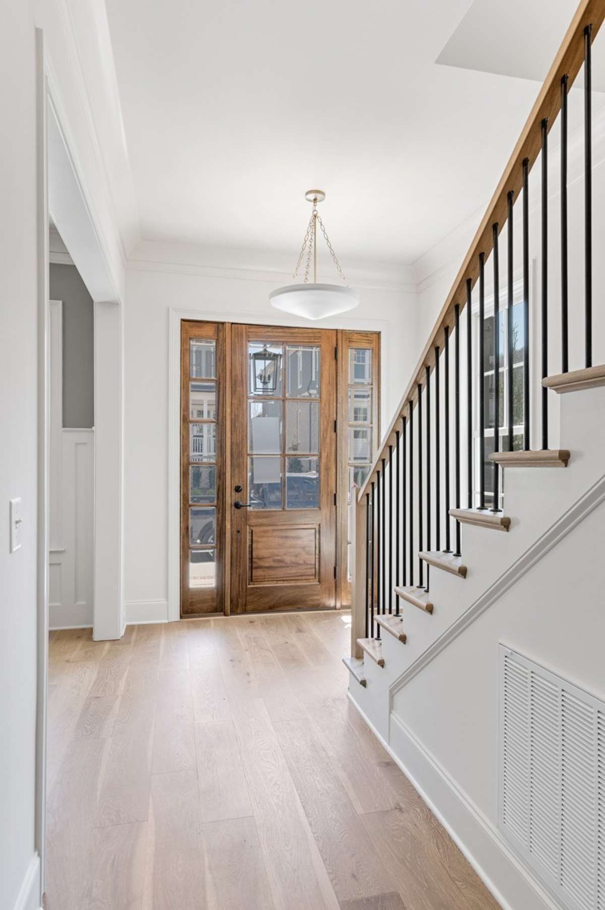 Welcoming entry foyer with hardwood flooring throughout main level.
