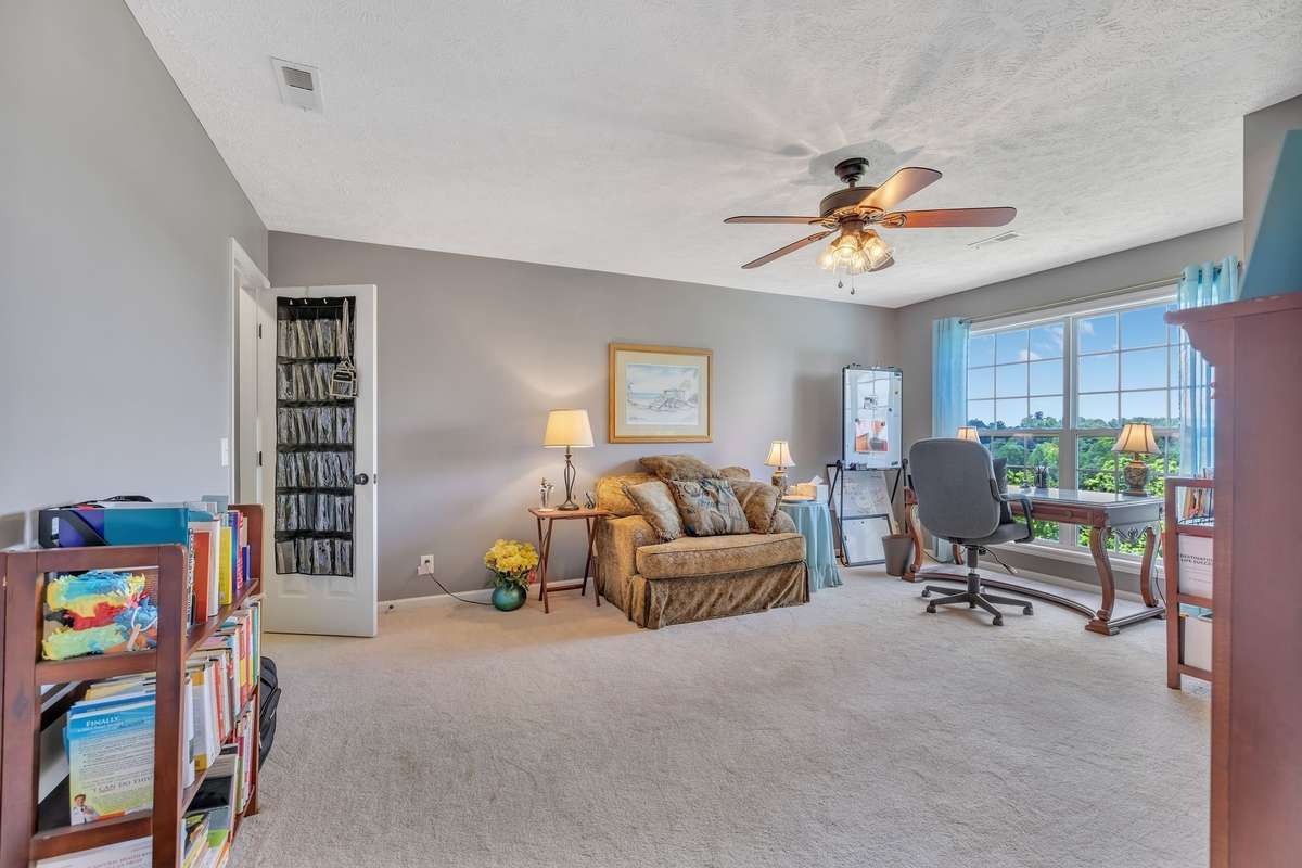 The third bedroom being used as a second office, also with a view of the lake. Walk-in closet leads to newly finished Bonus Room!