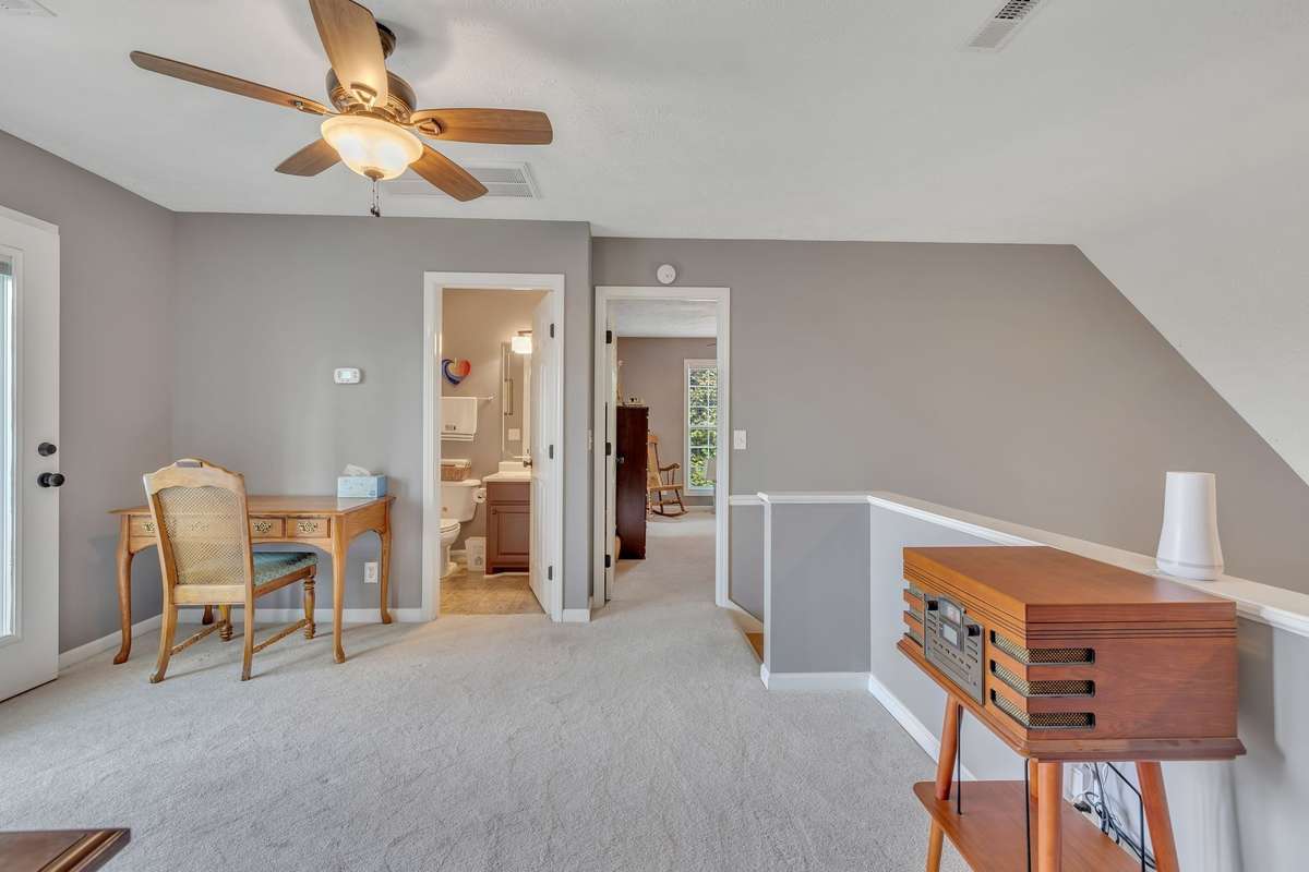 The landing with the full bathroom in the left door, the bedroom with an office overlooking the lake & a walk-in closet.