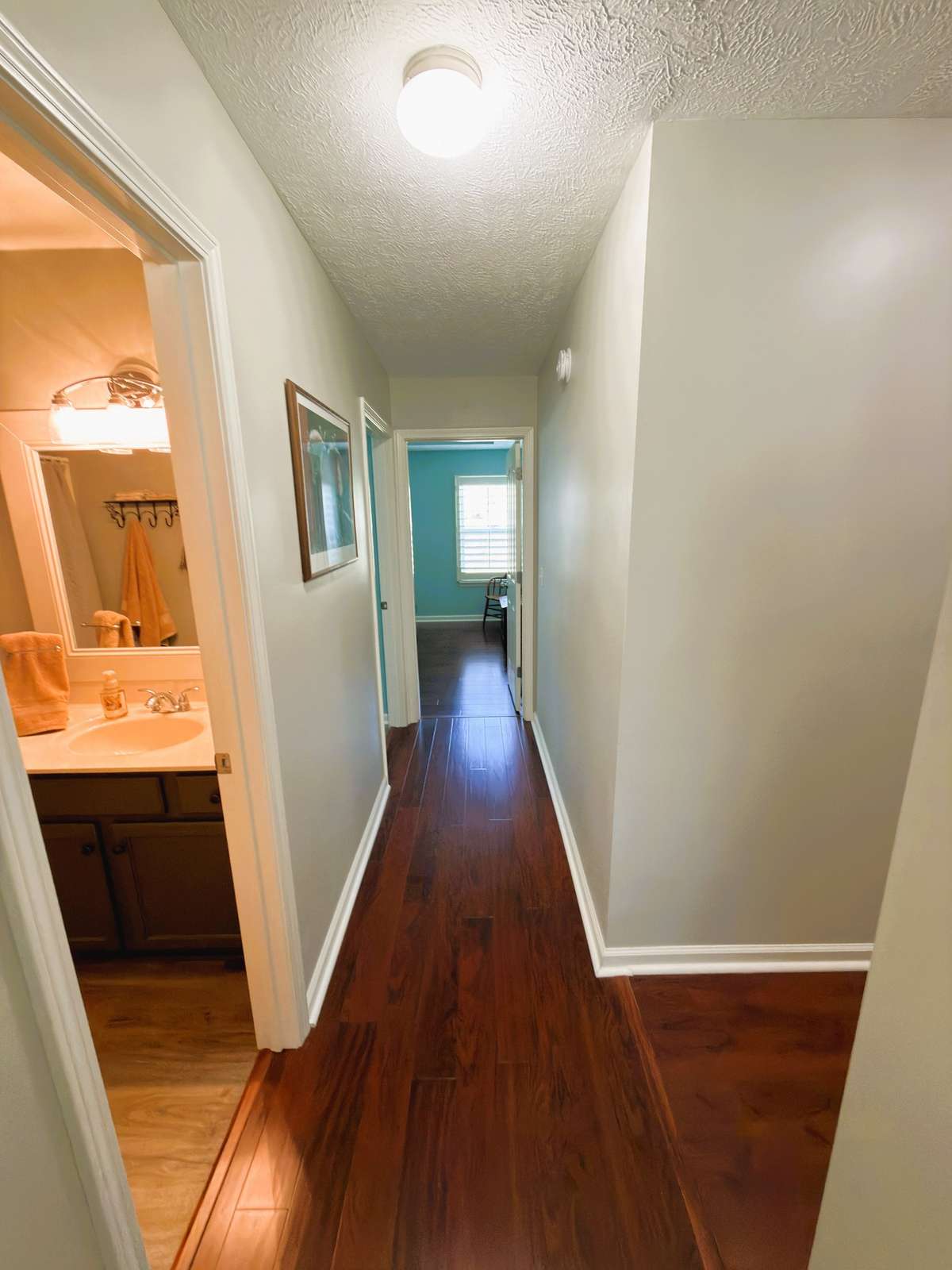Hallway between the primary bedroom and secondary bedrooms offers some privacy for the owners suite