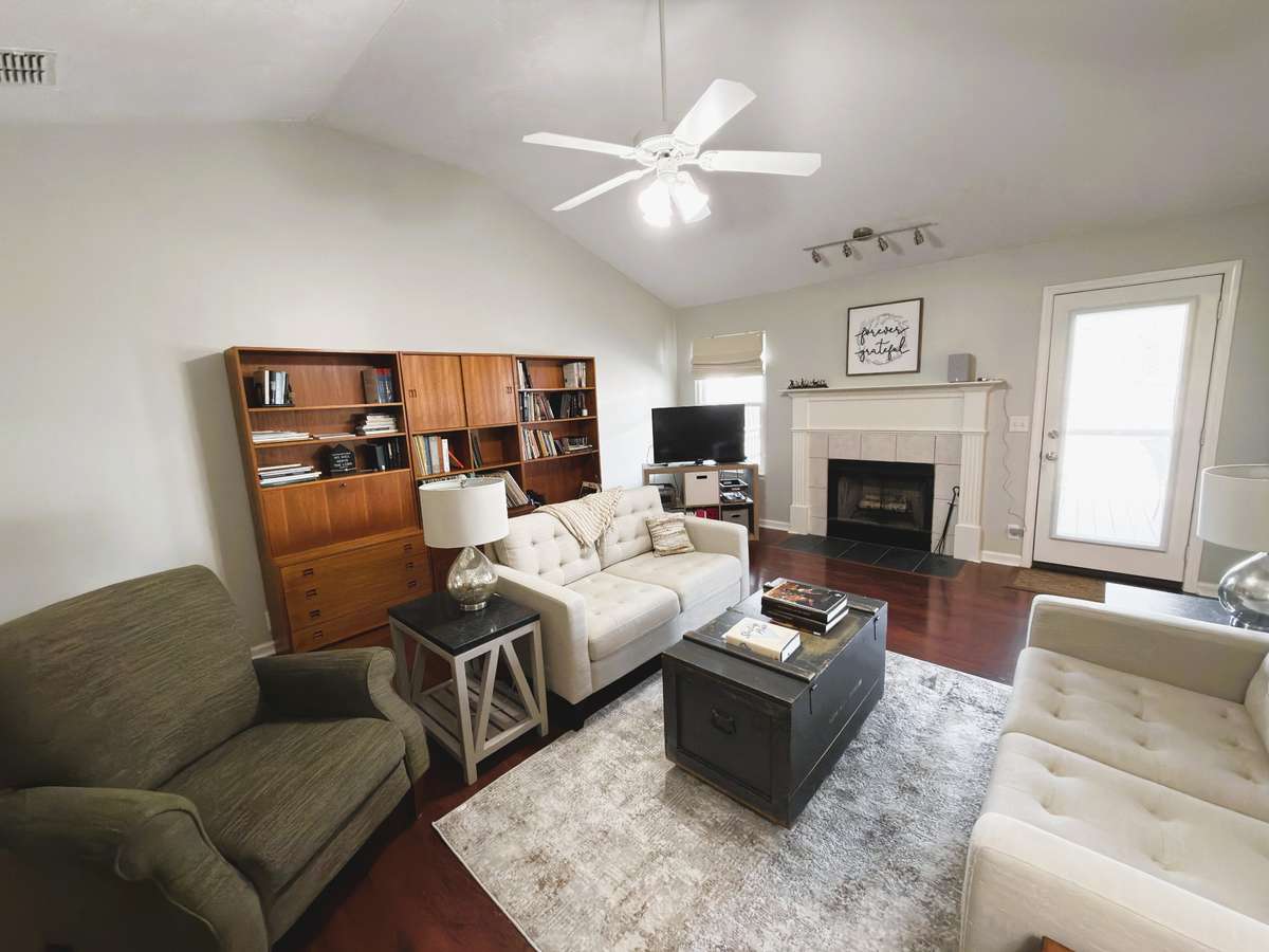 Vaulted ceiling and wood burning fireplace in this large great room