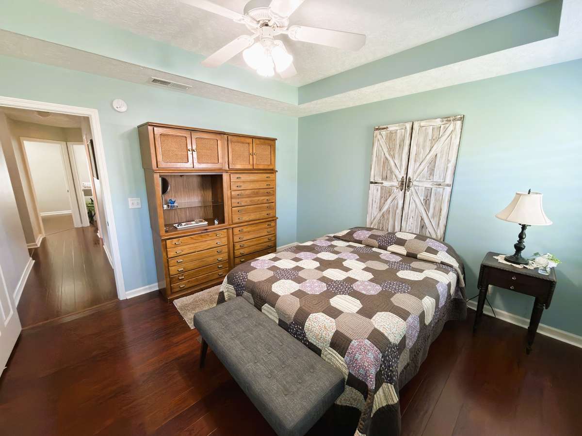 Primary bedroom features tray ceiling