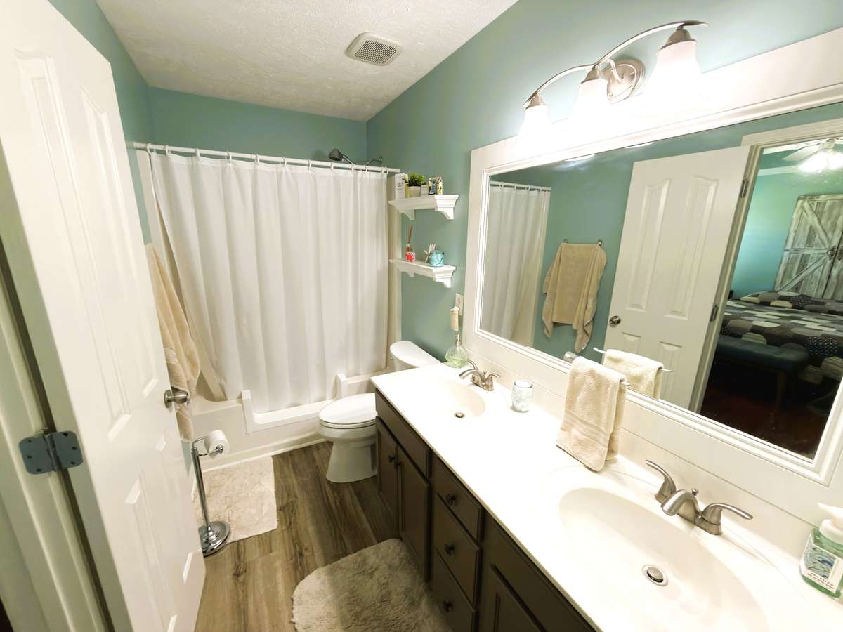 Primary bathroom has two vanities and a large walk in closet.