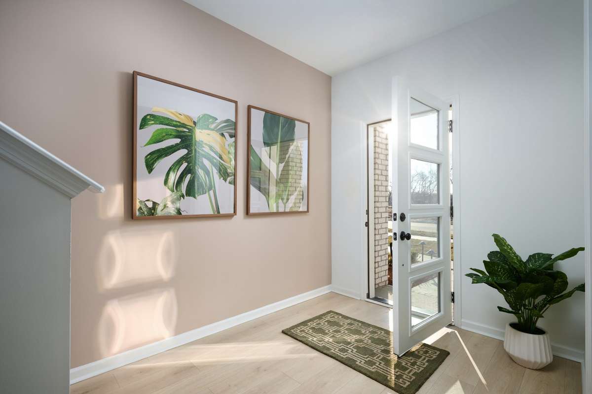 Entry door with glass to allow natural light into the home. Photo is of the same floorplan but is the furnished model. Design options may change- see sales for specifics.